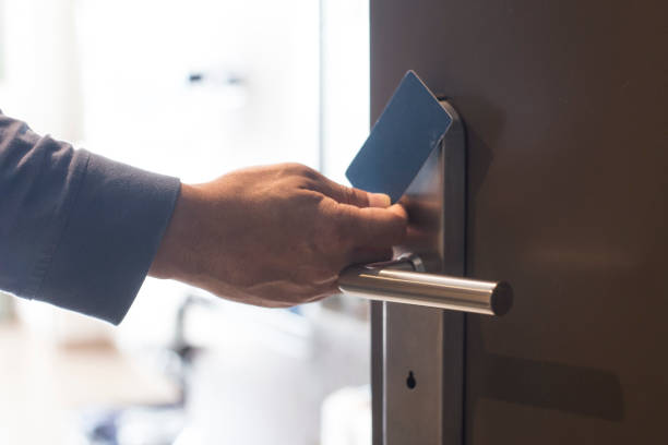hand touch keycard on hotel door stock photo
