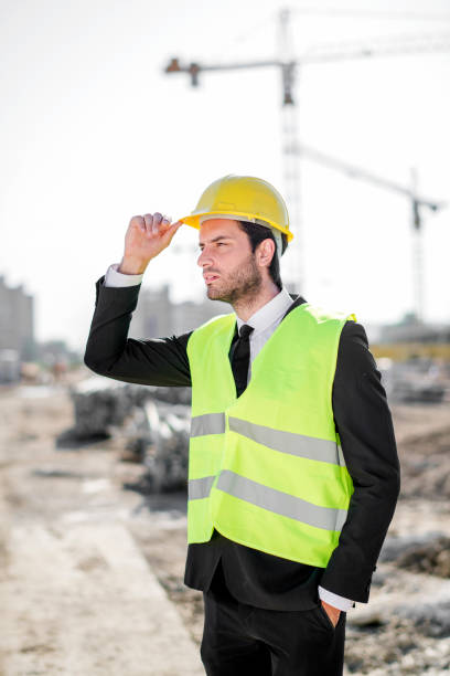 istock Professional engineer architect worker with protective helmet and blueprints paper construction site 1183768432