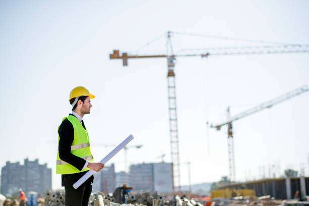 istock Professional engineer architect worker with protective helmet and blueprints paper construction site 1183769757
