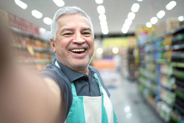 istock Senior supermarket employee talking a selfie 1183774589