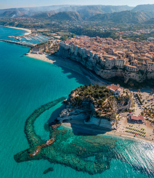 Aerial view of Tropea, house on the rock and Sanctuary of Santa Maria dell'Isola, Calabria. Italy. Aerial view of Tropea, house on the rock and Sanctuary of Santa Maria dell'Isola, Calabria. Italy. Tourist destinations of the most famous in Southern Italy, seaside resort located on a cliff in the gulf of Sant'Eufemia calabria stock pictures, royalty-free photos & images