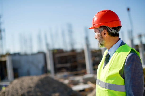 istock Professional engineer architect worker with protective helmet and blueprints paper construction site 1183775664