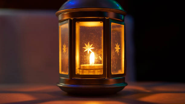 istock Ornamental lantern with burning candle glowing at night 1183777895