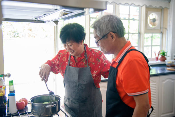 istock Senior couple enjoying cooking in the kitchen 1183778459