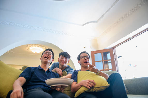 istock Excited fans cheering for sport team watching game 1183778595