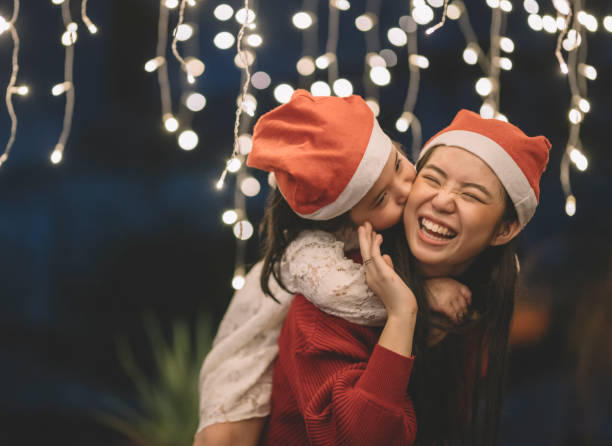 an asian chinese female carrying her sister from the back during christmas eve dinner celebration an asian chinese female carrying her sister from the back during christmas eve dinner celebration sister photos stock pictures, royalty-free photos & images
