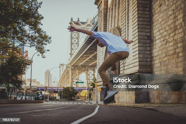 Skater Training In A Skate Park In New York Stock Photo - Download Image Now - Brooklyn Bridge, Skateboarding, Skateboard