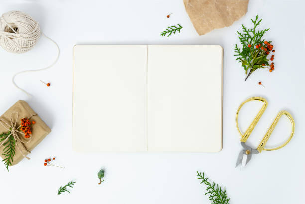 istock Christmas New Year presents frame on white background. Opened craft paper notebook mockup with copy space 1183783333