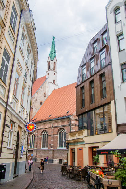 treet of old Riga. The neighborhood of modern architecture with ancient buildings. Riga, Latvia - July 13, 2018: Street of old Riga. The neighborhood of modern architecture with historic buildings. btc bit riga stock pictures, royalty-free photos & images