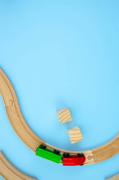 istock Vertical baby frame background with copy space. Colorful wooden train road and cubes frame mockup. Flat lay cubes, road and wooden train. Copy space for your text or banner on a blue backround 1183783803