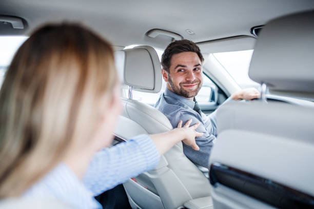 istock Happy young couple sitting in car, talking. 1183786241