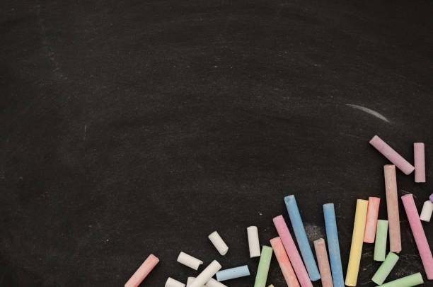 istock Flat lay colored chalk on a dark school board. Back to school mockup. Blackboard with copy space for text. Top view 1183786379