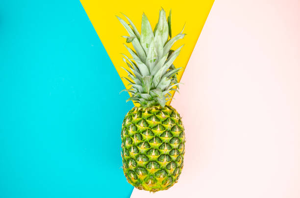 istock Top view pineapple. Summer minimal flat lay concept on mint, pink and yellow pop background 1183786638