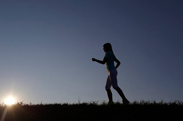 istock Woman jogging in sunset 118378851