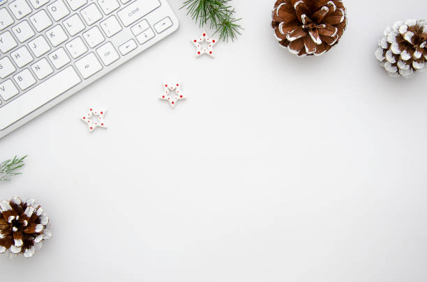 istock Top view home office desk with computer, pine branches and christmas decorations. Flat lay with white copy space. Christmas concept 1183788926