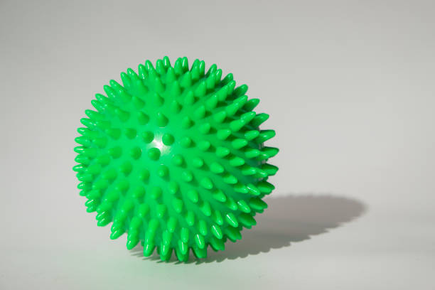 istock Spiky massage ball on the white background with hard lights and isometric shadow 1183792080