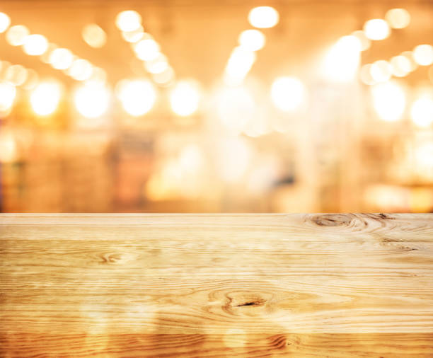 istock Wood texture table top (counter bar) with blur light gold bokeh in cafe,restaurant background 1183793227