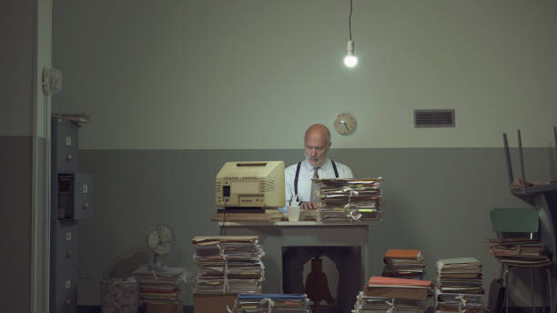 istock Frustrated businessman overloaded with paperwork 1183795082