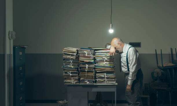 istock Desperate business executive with lots of paperwork 1183795100