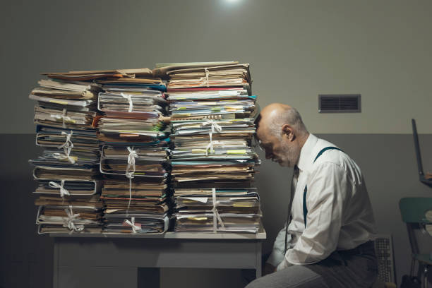 istock Desperate business executive with lots of paperwork 1183795338