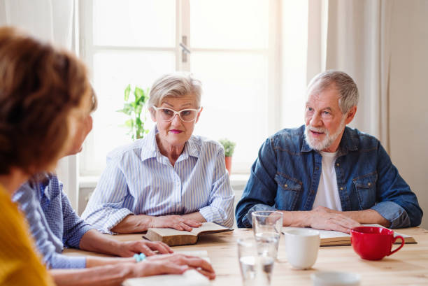 istock Senior people in bible reading group in community center club. 1183796708