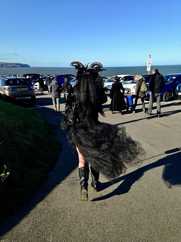 October 27th 2019, Whitby, North Yorkshire, England, UK.\n\nThere were some excellent costumes on show at this Goth weekend held at Whitby.  \n\nThis mysterious striking Goth lady with a goat-horn headdress caught my eye, as she meandered her way through the crowds towards the cliff pavilion.  She walked quickly, as if in some haste to fulfil some appointment with destiny...or maybe just a quite drink with her Goth friends