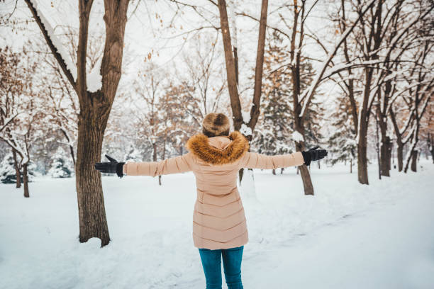 istock Young woman enjoying in snow 1183798508