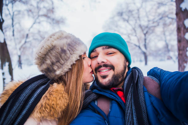 istock Couple taking selfie in winter park 1183798579