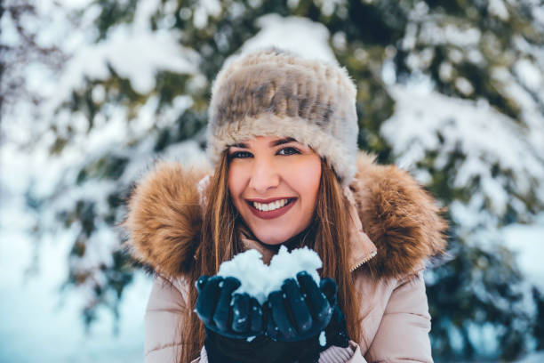 istock Woman holding snow 1183798631
