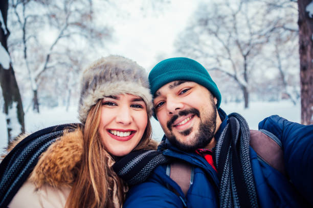 istock Couple taking selfie in winter park 1183798724
