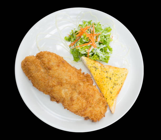 istock Breaded fried fish with bread and Vegetable isolated on the black background with clipping path,top view 1183799837