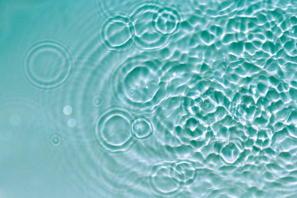 istock Water abstract background with blue rippled aqua texture, splash circle reflections in swimming pool. Top view 1183800085