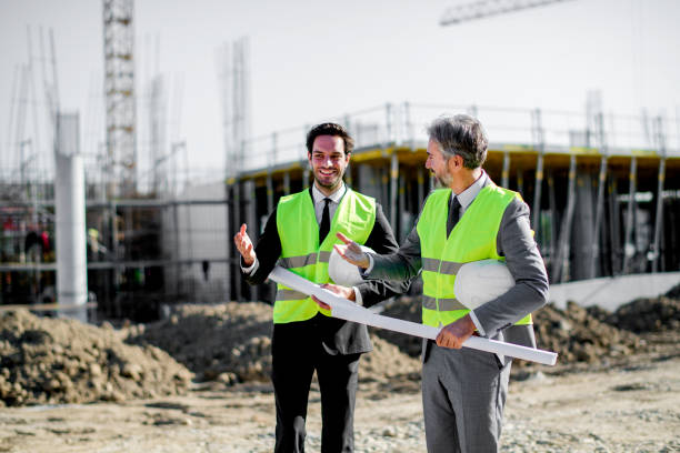 istock Senior and mid adult architect  on a construction site 1183801435