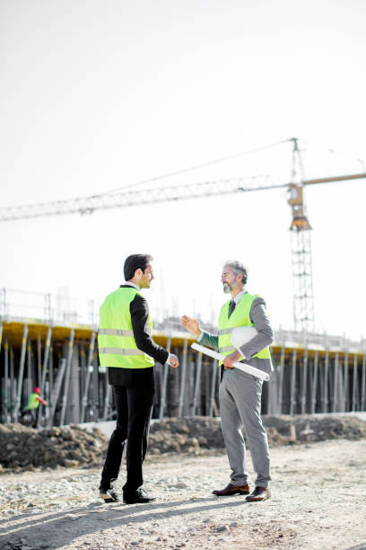istock Senior investor and mid adult architect  on a construction site 1183801855