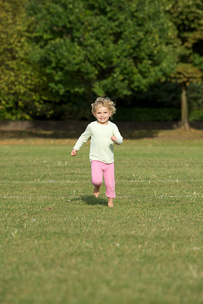 istock Young girl running in a park 118380220
