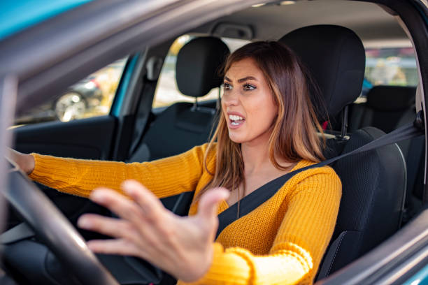 istock Angry woman driving a car. 1183802600