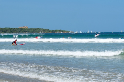 surfers at Tamarindo beach in Costa Rica
