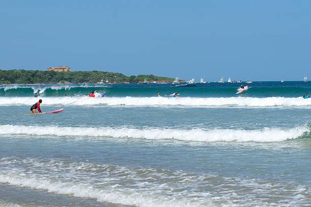 Surfers at beach stock photo