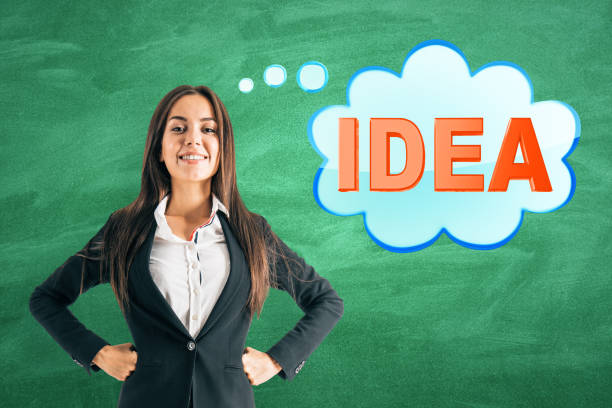 istock Businesswoman with idea on chalkboard background 1183802945