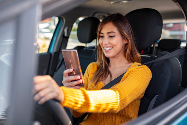 istock Woman typing message on the phone while waiting in the car. 1183803065