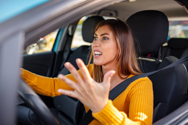 istock Beautiful angry woman honking in her car while driving 1183803087