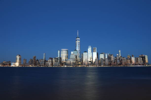 New York city Manhattan downtown skyline modern office building financial district skyscrapers night New York city Manhattan downtown skyline modern office building financial district skyscrapers night new york city built structure building exterior aerial view stock pictures, royalty-free photos & images
