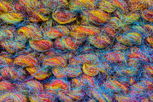 extreme close up of knitted stitches of colorful yarn