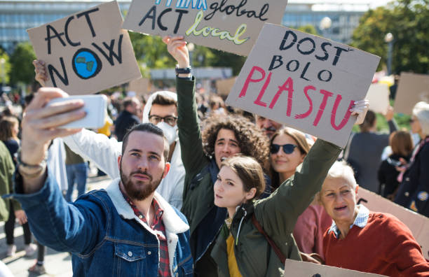 istock People with placards and posters on global strike for climate change, taking selfie. 1183805693