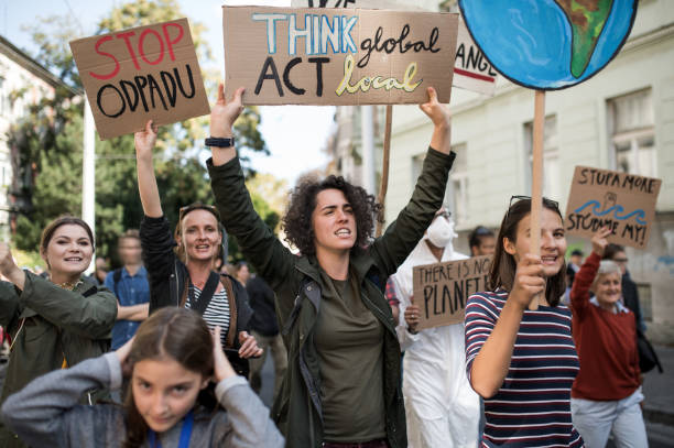 istock People with placards and posters on global strike for climate change, shouting. 1183805771