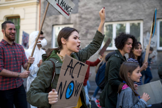 istock People with placards and posters on global strike for climate change, shouting. 1183805875