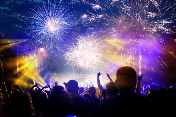 istock crowd celebrating New Year with fireworks 1183805897