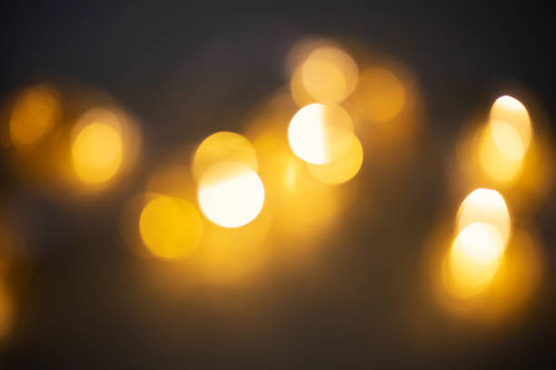 istock Blurred garland light. Golden bokeh on black background,blurred garland light 1183805943