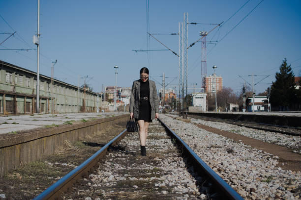 istock Girl on railway station 1183808540