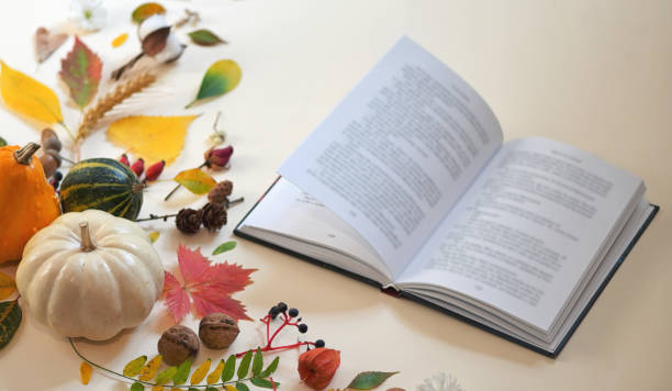 istock Autumn decoration and open book on table 1183808767
